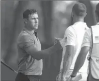  ?? The Associated Press ?? SHOWING MUSCLE: Brooks Koepka, left, shakes hands with Dustin Johnson Friday after they completed the second round of the Northern Trust PGA golf tournament at Ridgewood Country Club in Paramus, N.J.