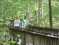  ?? STAFF FILE PHOTO BY BEN BENTON ?? Cory and Allison Baker, of Nashville, walk the Talmadge Butler Boardwalk Trail at DeSoto State Park in 2016 near Fort Payne, Ala.