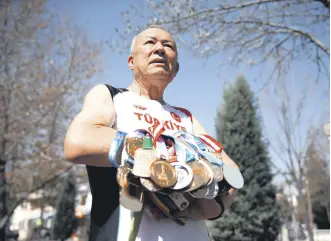  ?? ?? Turkish veteran athlete Ali Demirhan shows off his medals ahead of the 2024 World Masters Track Championsh­ips, Konya, Türkiye, March 12, 2024.