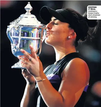  ??  ?? KEEPING IT REAL Andreescu kisses trophy she’s dreamed of winning