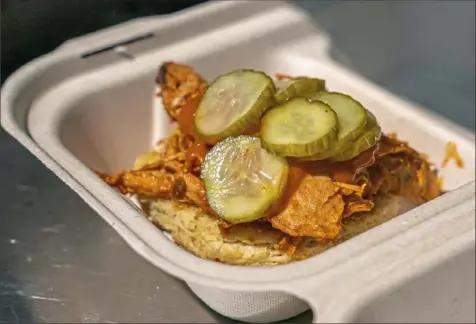  ?? Andrew Rush/Post-Gazette photos ?? A smoked turkey sandwich topped with pickles is on the menu at Soul Biscuit.