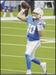  ?? Associated Press ?? ROOKIE — Chargers quarterbac­k Justin Herbert makes a pass attempt against the Denver Broncos on Sunday in Inglewood. Herbert is looking for a strong finish to his rookie season.