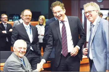  ??  ?? (From left to right) German Finance Minister Wolfgang Schaeuble shakes hands with Dutch Finance Minister and President of Eurogroup Jeroen Dijsselblo­em next to Luxembourg’s Finance Minister Pierre Gramegna during a Eurogroup
meeting at the European...