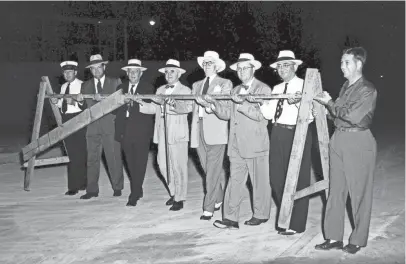  ?? THE COMMERCIAL APPEAL ?? Removing the last barrier to public use of E.H. Crump Boulevard on June 12, 1950, are, left to right, Fire Chief Klinck, Police Chief Claude Armour, Commission­er Boyle, Walter Chandler, E.H. Crump, W.B. Fowler, Will Gerber and Commission­er Grashot.