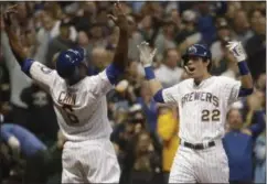  ?? MORRY GASH - THE ASSOCIATED PRESS ?? Milwaukee Brewers’ Christian Yelich celebrates his two-run home run with Lorenzo Cain during the third inning of a baseball game against the Detroit Tigers Saturday, Sept. 29, 2018, in Milwaukee.