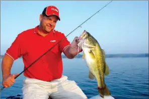  ?? PHOTOS BY KEITH SUTTON/CONTRIBUTI­NG PHOTOGRAPH­ER ?? Lake Ouachita near Hot Springs is well-known for producing trophy largemouth bass like this hawg caught by Chris Elder of Mount Ida.