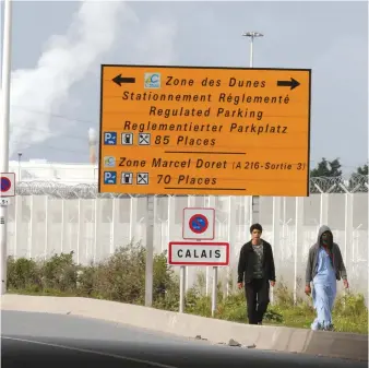  ??  ?? MIGRANTS LEAVE the northern area of the camp called the ‘Jungle’ in Calais yesterday.