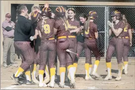  ?? Photo by Becky Polaski ?? Emily Mourer is congratula­ted by her teammates after rounding the bases for ECC’s first home run of the season on Wednesday afternoon.