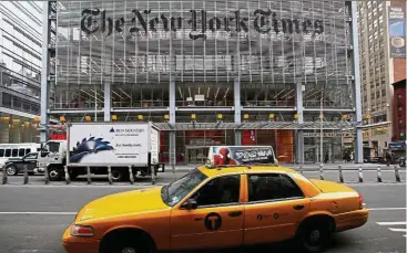  ?? – Reuters ?? Revamp: A taxi passes by in front of The New York Times head office in New York. The publicatio­n is doing away with its public editor.