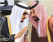  ?? Associated Press ?? In this May 14, 2012, file photo, King Salman, left, speaks with his son, now Crown Prince Mohammed Bin Salman, as they wait for Gulf Arab leaders ahead of the opening of Gulf Cooperatio­n Council in Riyadh, Saudi Arabia.