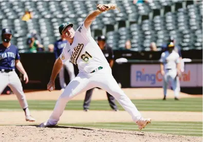  ?? Santiago Mejia / The Chronicle ?? A’s relief pitcher Zach Jackson pitches in the ninth inning against the Seattle Mariners at the Coliseum on June 23. Jackson entered Friday with 42 strikeouts in 292⁄3 innings in the majors this season.