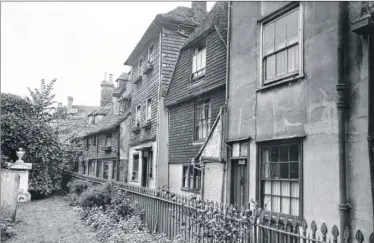  ??  ?? The Churchyard, 1941. At first glance you wouldn’t think the Churchyard and rear of the buildings in the High Street have changed much, but look closely and the squared bay which today exists at the rear of No 63 High Street (seen here with No 59 and...