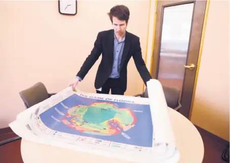  ?? Scott Strazzante / The Chronicle ?? Above: Alex Westhoff, a Marin County planner, sets up the Game of Floods board game in San Rafael.