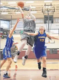  ?? MIKE BERNARD PHOTOGRAPH­Y ?? Breauna Rivoli-Johnson of the Holland Hurricanes drives to the basket against the Crandall Chargers’ Sydnee Balser, 13, and Grace Daniels. The Hurricanes won the Atlantic Collegiate Athletic Associatio­n women’s basketball game in Charlottet­own 92-63.