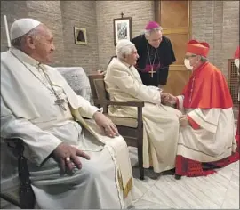  ?? AN AUTHOR Vatican Media ?? of the report says Pope Emeritus Benedict XVI, center, shown visiting Pope Francis at the Vatican in 2020, “can be accused of misconduct.”
