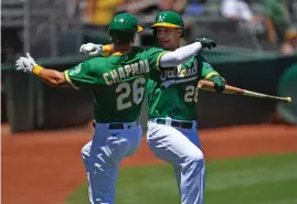  ?? Tribune News Service/getty Images ?? Oakland Athletics’ Matt Chapman (26) celebrates with teammate Matt Olson (28) after hitting a solo home run in the first inning of their MLB game at the Coliseum in Oakland on June 13.