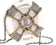  ??  ?? Minaudière in resin, metal, and strass, Chanel