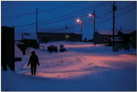  ?? (AP file photo/Gregory Bull) ?? A woman walks in Toksook Bay, Alaska, a mostly Yuip’ik village on the edge of the Bering Sea. The U.S. Supreme Court will hear oral arguments Monday in a case that will determine who is eligible to receive more than $530 million in federal coronaviru­s relief funding set aside for tribes more than a year ago.