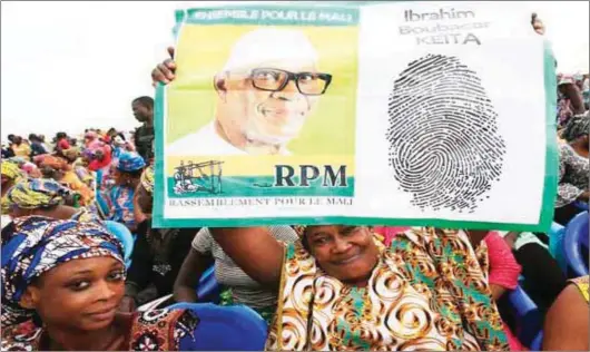  ??  ?? Supporters of Mali’s President Ibrahim Boubacar Keita in the capital Bamako. Legnan Koula/EPA/EFE.