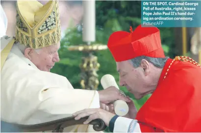  ?? Picture:AFP ?? ON THE SPOT. Cardinal George Pell of Australia, right, kisses Pope John Paul II’s hand during an ordination ceremony.