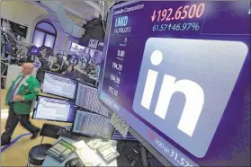  ?? RICHARD DREW/ASSOCIATED PRESS ?? The LinkedIn logo appears on a screen Monday at the post where it trades on the floor of the New York Stock Exchange. In a surprise move, Microsoft said Monday that it is buying profession­al networking service site LinkedIn for about $26.2 billion.