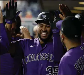  ?? Tim Nwachukwu / Getty Images ?? The Rockies’ Elias Diaz celebrates after hitting a grand slam during the ninth inning against the Phillies at Citizens Bank Park on Friday in Philadelph­ia.