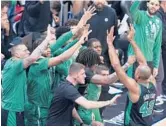  ?? WILFREDO LEE/AP ?? Al Horford (42) celebrates with teammates during the Celtics’ 93-80 win over the Heat in Game 5 of the Eastern Conference finals on Wednesday.