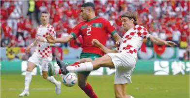  ?? — AFP ?? Morocco’s defender Achraf Hakimi and Croatia’s defender Borna Sosa fight for the ball at the Al Bayt Stadium in Al Khor.