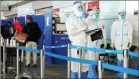  ?? GETTY IMAGES ?? Quarantine officers monitor arrivals at Beijing Capital Internatio­nal Airport on Jan 4.