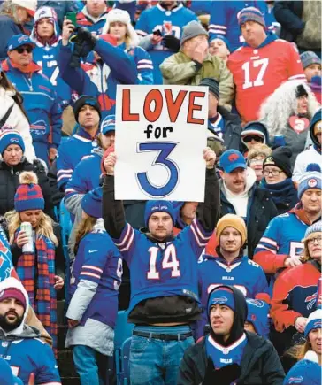  ?? JEFFREY T. BARNES/AP ?? A fan holds a sign in support of safety Damar Hamlin during the Bills’ victory over the Patriots on Sunday.