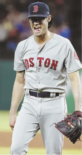  ?? AP PHOTO ?? ESCAPE ARTIST: Joe Kelly walks back to the dugout after getting out of an eighth-inning jam during the Red Sox' 6-5 victory against the Texas Rangers last night in ArlingtBos­ton Red Sox relief pitcher Joe