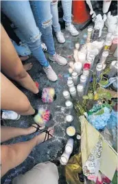  ?? AP FILE ?? Fans and mourners gather at a memorial for rap singer XXXTentaci­on last Tuesday outside Riva Motorsport­s in Deerfield Beach, where he was slain.