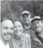  ?? New York Times ?? Amanda Eller is shown with her rescuers. She had been lost in a forest reserve on Maui.