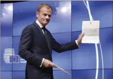  ??  ?? EU Council President Donald Tusk grimaces at a press conference Wednesday in Brussels, Belgium, showing the letter he received signed by Britain's Prime Minister Theresa May formally triggered the beginning of Britain's exit from the European Union. AP PHOTO