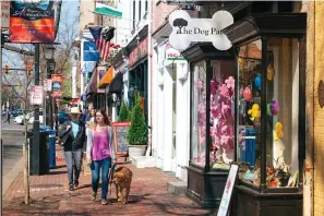  ?? Matt Chenet/ Visit Alexandria/TNS ?? ■ LEFT: A dog takes its human for a walk on King Street. Alexandria is one of America’s most dog-friendly cities.