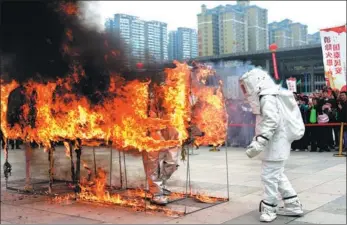  ?? LIU CHAOFU / FOR CHINA DAILY ?? Firefighte­rs participat­e in a rescue exercise in Xingyi, Guizhou province, on Thursday. The date, Nov 9, reflects China’s emergency telephone number for fires — 119 — making it the ideal day to raise public awareness of fire safety.