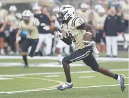  ?? STAFF PHOTO BY MATT HAMILTON ?? Bradley Central Marcus Goree Jr. (8) runs for a touchdown after a catch in 2022 against Walker Valley at Bradley Central High School in Cleveland.