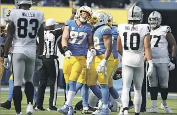  ?? Robert Gauthier Los Angeles Times ?? JOEY BOSA (97), shown with Khalil Mack, is set to return after suffering a core-muscle injury in September.