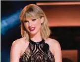  ??  ?? File photo shows Taylor Swift presents the award for entertaine­r of the year at the 50th annual CMA Awards in Nashville, Tenn. — AP