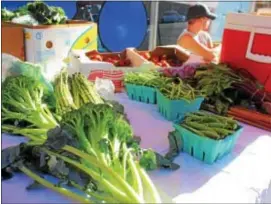  ?? MICHILEA PATTERSON — DIGITAL FIRST MEDIA ?? Produce such as broccoli, radishes and asparagus are on display during an outdoor farmers market in Pottstown. Asparagus are on the “Clean 15” list, which is a group of vegetables and fruits found to be the least likely to have pesticide residues when...