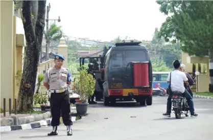  ??  ?? MEDAN: A police officer stands guard near a bomb disposal truck at the entrance to the North Sumatra Regional Police headquarte­rs in Medan, Indonesia. — AP