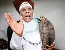  ??  ?? IN HER STRIDE: Nongoku Mavula Kuvaliwe Makinana in her consultati­on hut. Along with traditiona­l medicine, she has tortoises which help her in her mediumship.