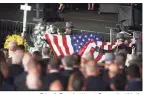  ?? Brian A. Pounds / Hearst Connecticu­t Media ?? State troopers fold the flag from the casket of fellow trooper Sgt. Brian Mohl during his funeral service at the Xfinity Theatre in Hartford on Thursday.
