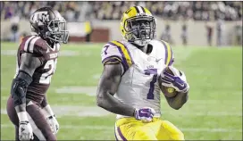  ?? DAVID J. PHILLIP / ASSOCIATED PRESS ?? LSU’s Leonard Fournette, who ran for a career-high 146 yards on 19 carries, scores on a 22-yard run in front of Texas A&M’s Deshazor Everett.