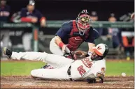  ?? Julio Cortez / Associated Press ?? The Orioles’ Kelvin Gutierrez scores as Red Sox catcher Kevin Plawecki tries to field a throw during the sixth inning on Thursday in Baltimore.