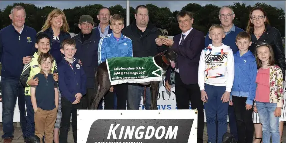  ?? Photo by www.deniswalsh­photograph­y.com ?? Sponsor Dan Dowling presents the winner’s trophy to winning owner John O’Donoghue after Killahas Brandy won the Dan and Chris Dowling and Family Buster Final at the Ballydonog­hue GAA Benefit Night at the Dogs on Saturday. Included, from left, are Paddy...
