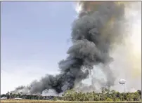  ?? TIMES LUIS SANTANA / TAMPA BAY ?? Aircraft from the U.S. Forestry Service and the Florida Forestry Service work to contain a massive wildfire on Saturday in Hernando Beach. Southwest Florida is the driest region in the state, according to forest service data, and Lee County is the...