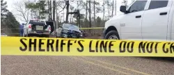  ?? Photo by J.D. Bailey/Banner-News ?? ■ Police tape ropes off the scene Monday at Columbia roads 11 and 13 in Calhoun community, Ark., after two adults were found dead in a car fire. Authoritie­s are investigat­ing the incident as a homicide.