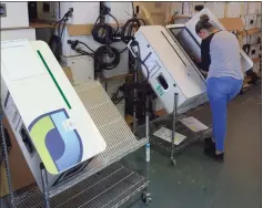  ?? H John Voorhees III / Hearst Connecticu­t Media ?? An employee assembles a JuiceBar EV charger at Gyre9 in Oxford, which is moving to a larger space in Southbury.