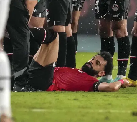  ?? AP ?? Egypt striker Mohamed Salah receives treatment after being injured during the Afcon Group B match against Ghana last week